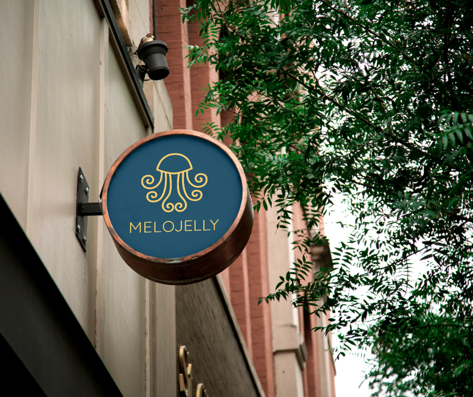 A store sign on the side of a building with MeloJelly's logo on it.