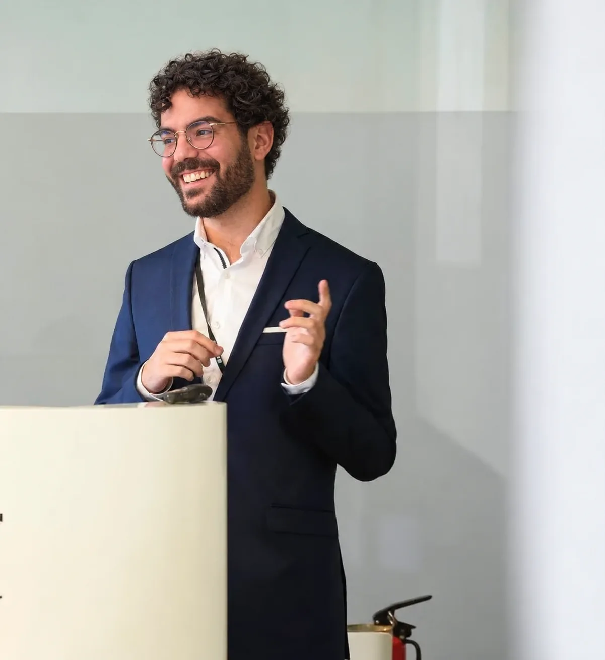 João Monteiro presenting from a lectern, smiling